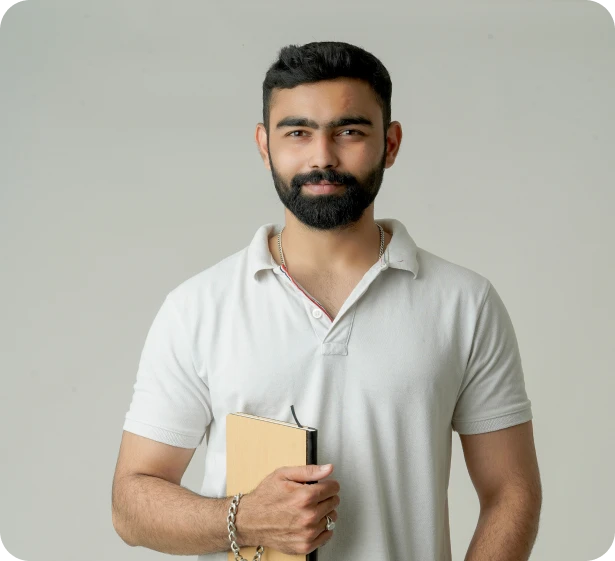 young_indian_man_standing_with_note_book_isolated_white Young Indian Man Standing With Note Book Isolated White